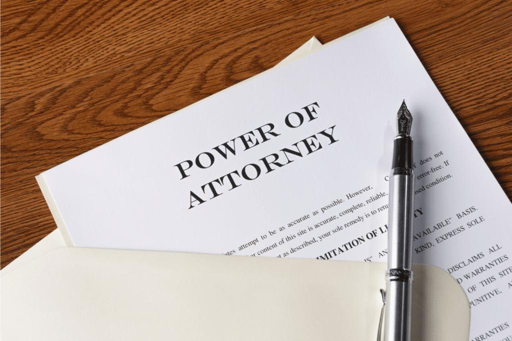 Power of Attorney document with a pen on a wooden table.