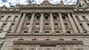 Front view of the historic New York County Surrogate’s Court building with grand columns and ornate stonework.